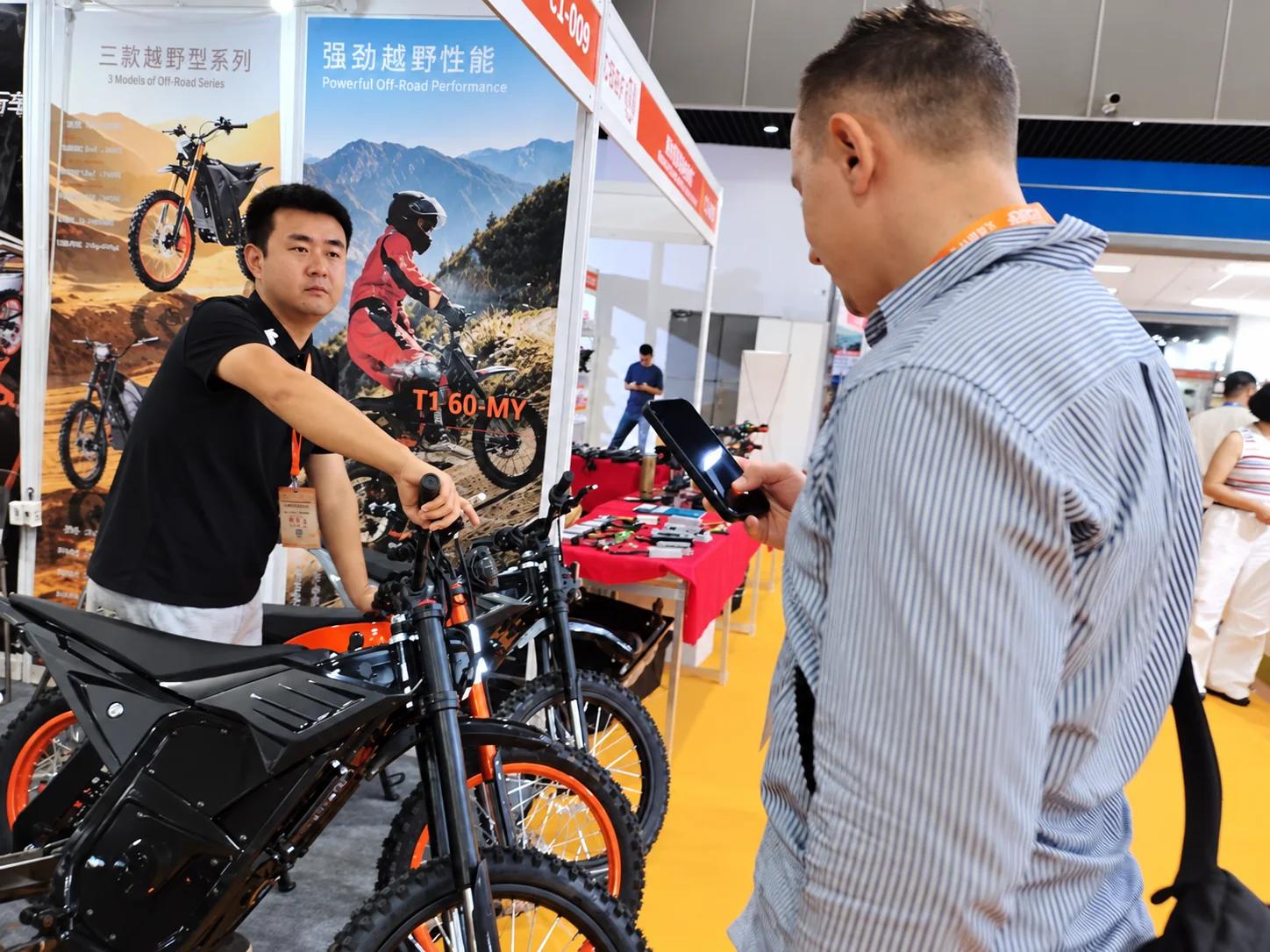 KMS team presenting electric motorcycles to trade visitors
